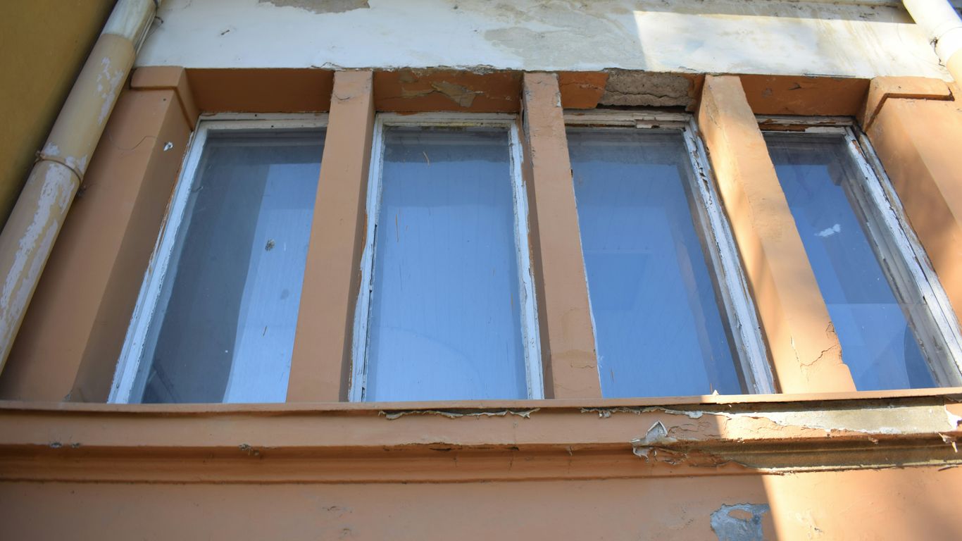 a building with a window that has been boarded up