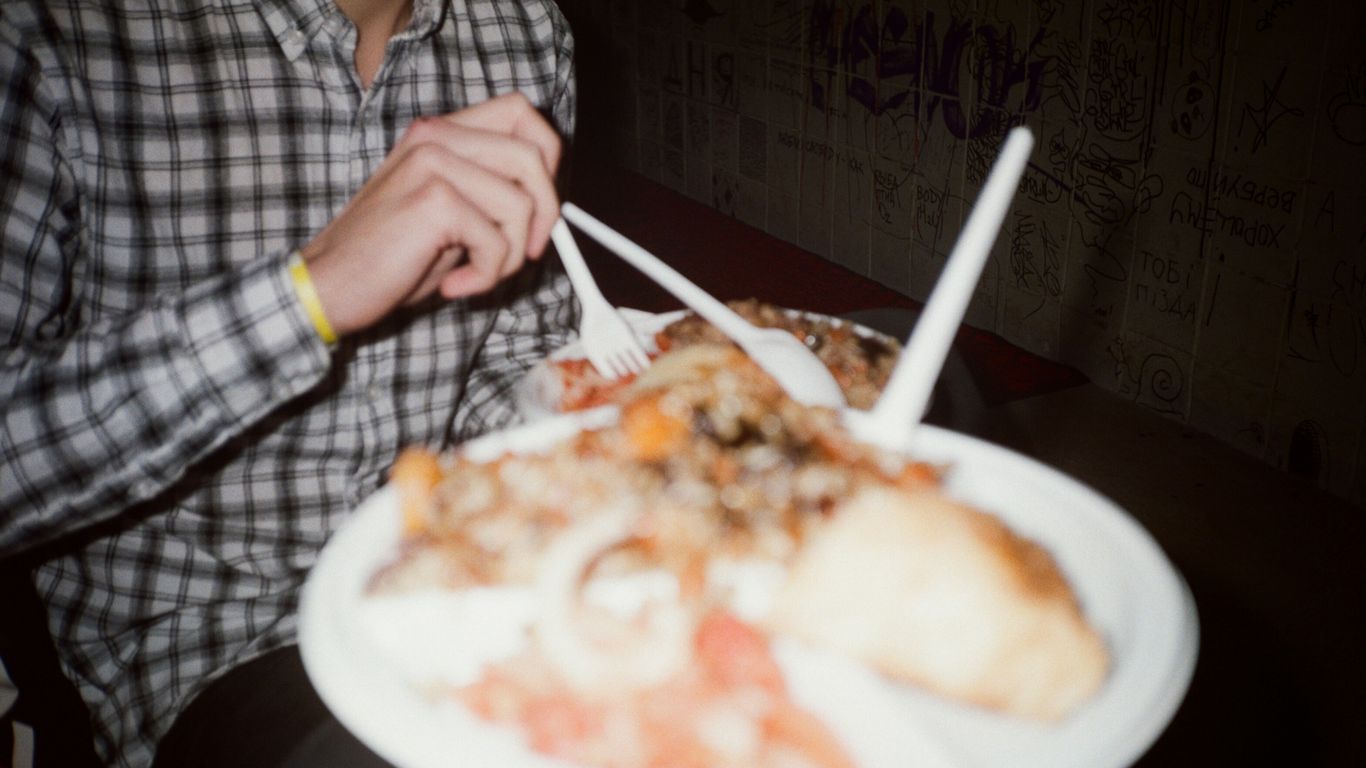 person holding white ceramic plate with food