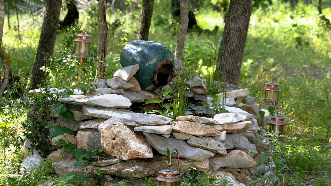 brown and gray rocks on green grass field during daytime