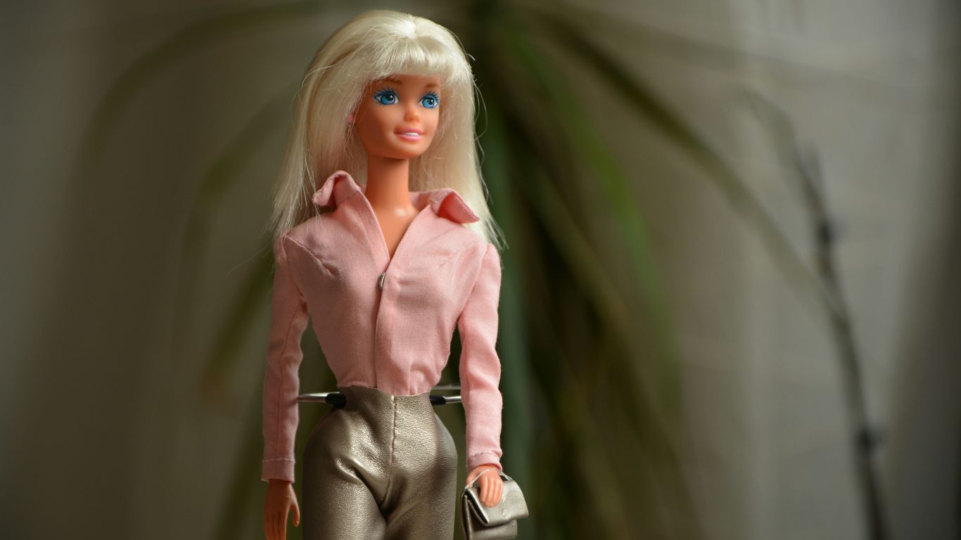 woman in pink dress shirt and gray pants