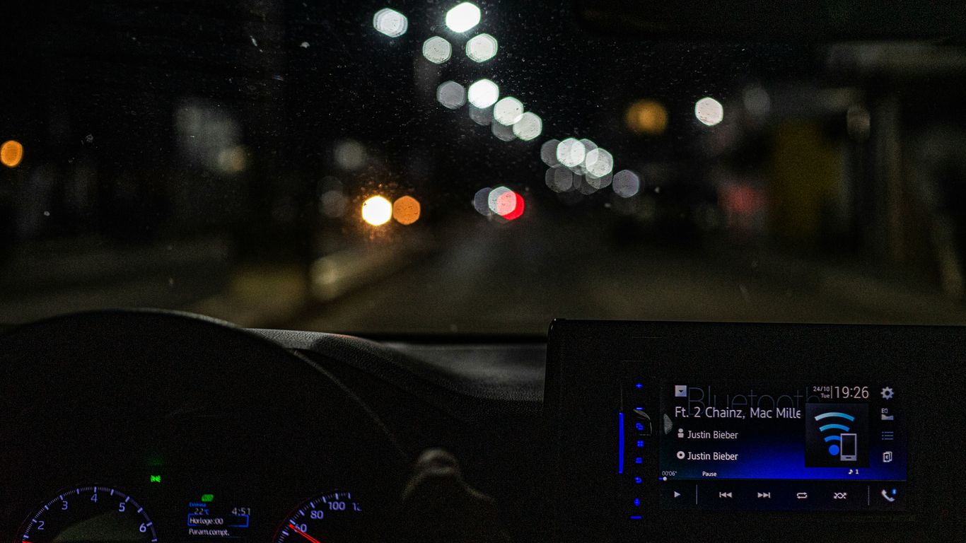 the dashboard of a car at night time