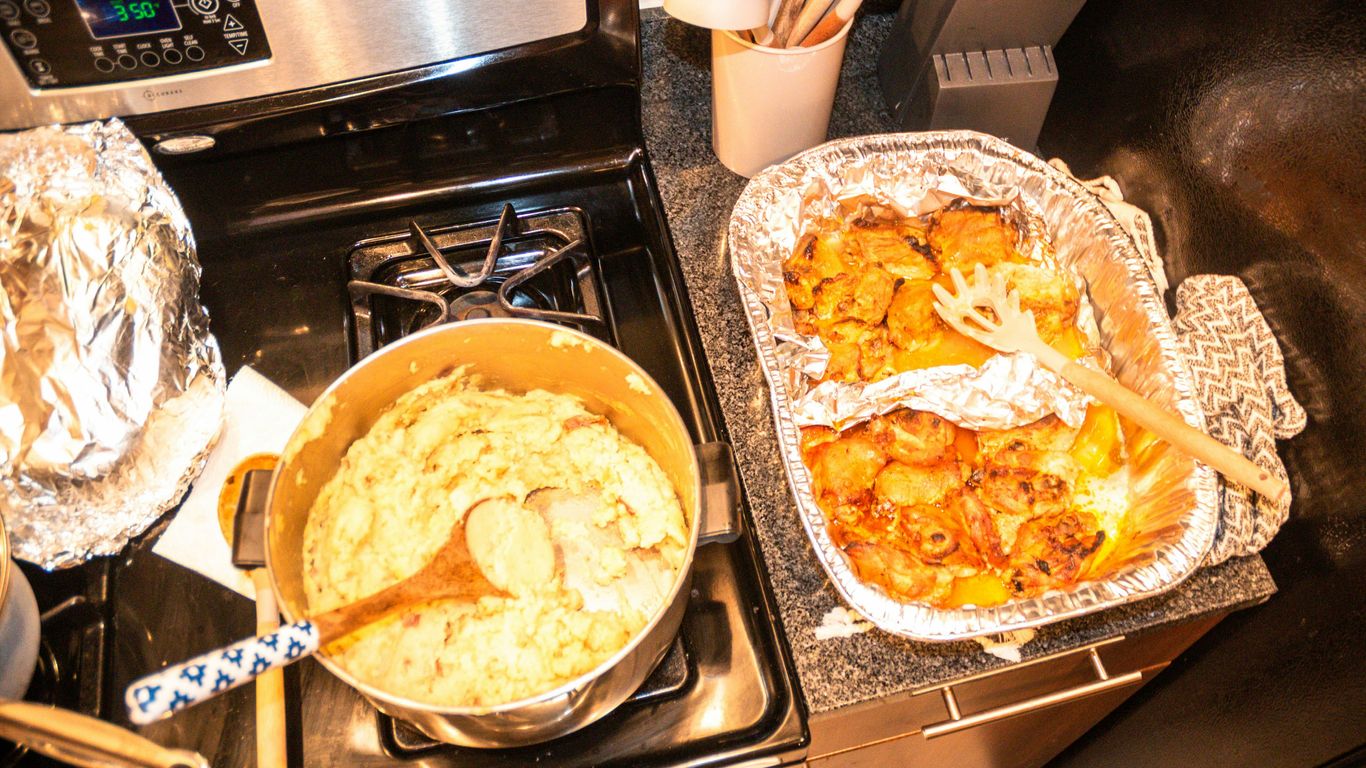 two pans of food sitting on top of a stove