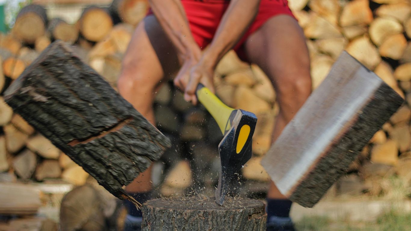 a person cutting wood with scissors