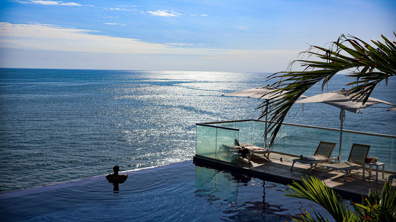 A large swimming pool next to the ocean