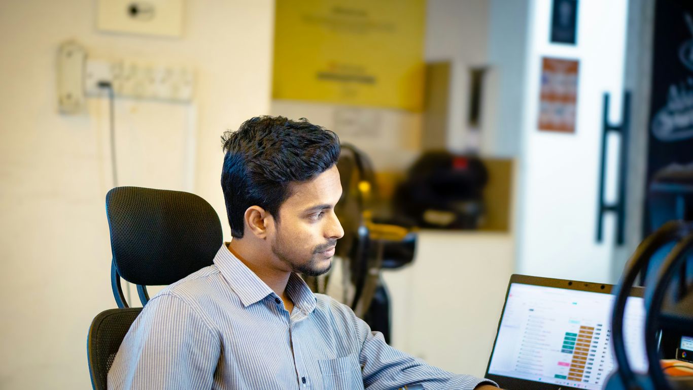 A man sitting in front of a laptop computer