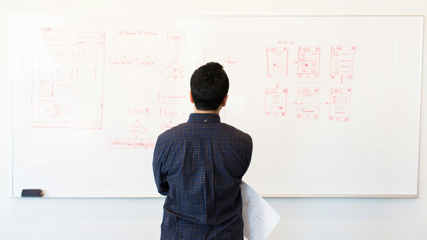 man standing near whiteboard