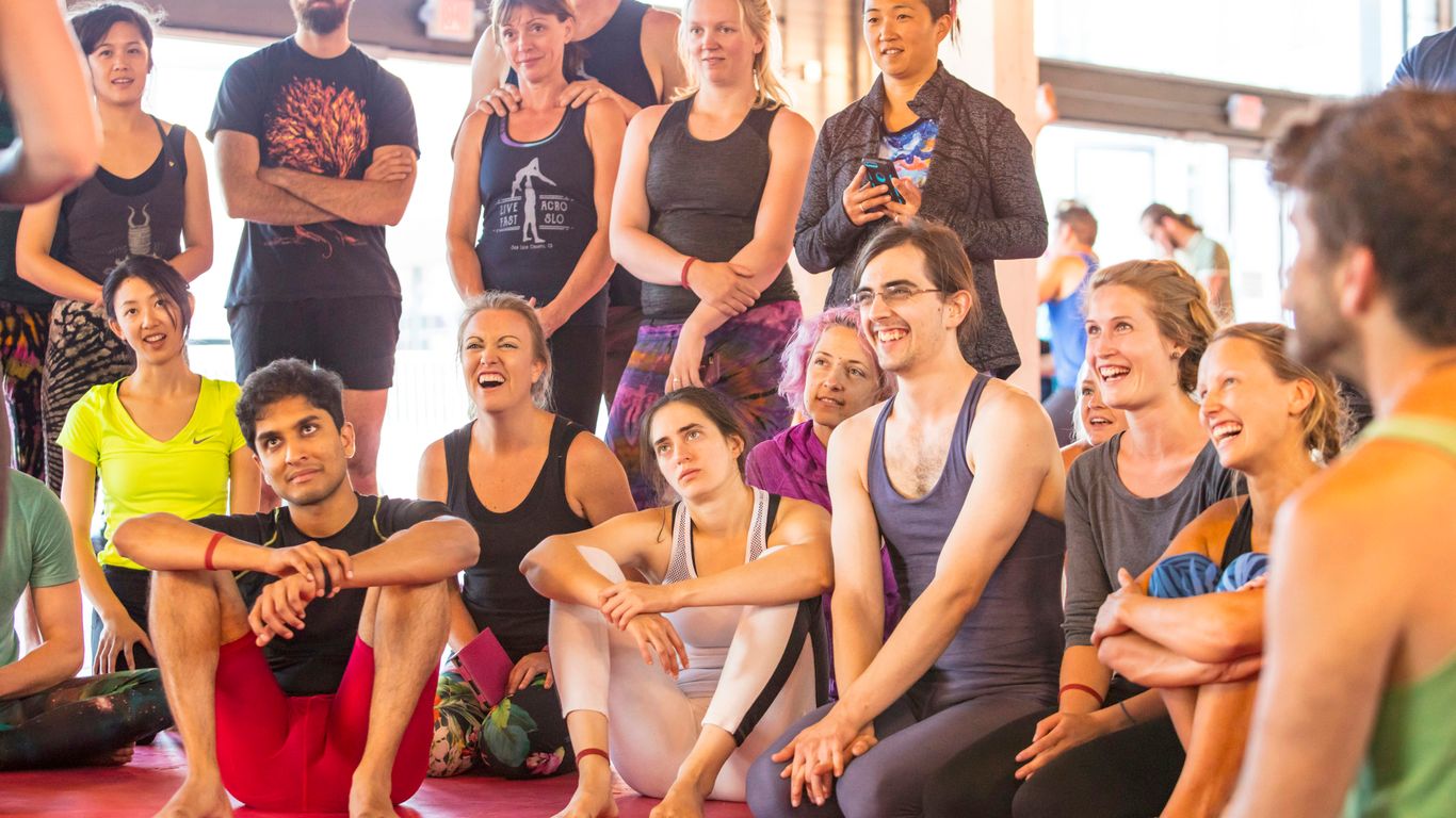 a group of people sitting and standing around each other