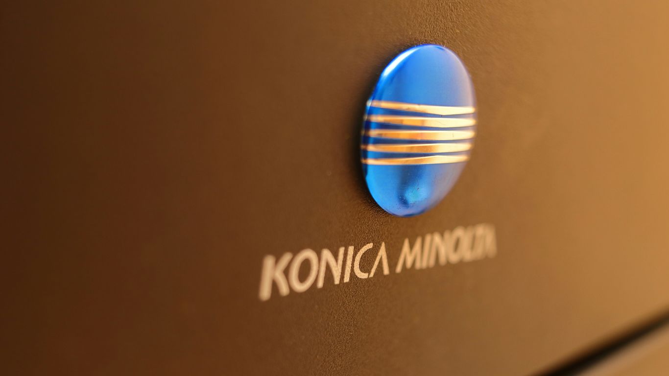 Konica minolta logo on a dark surface