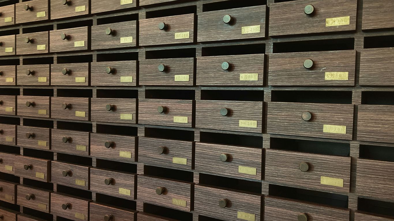 A wall full of many drawers in a room