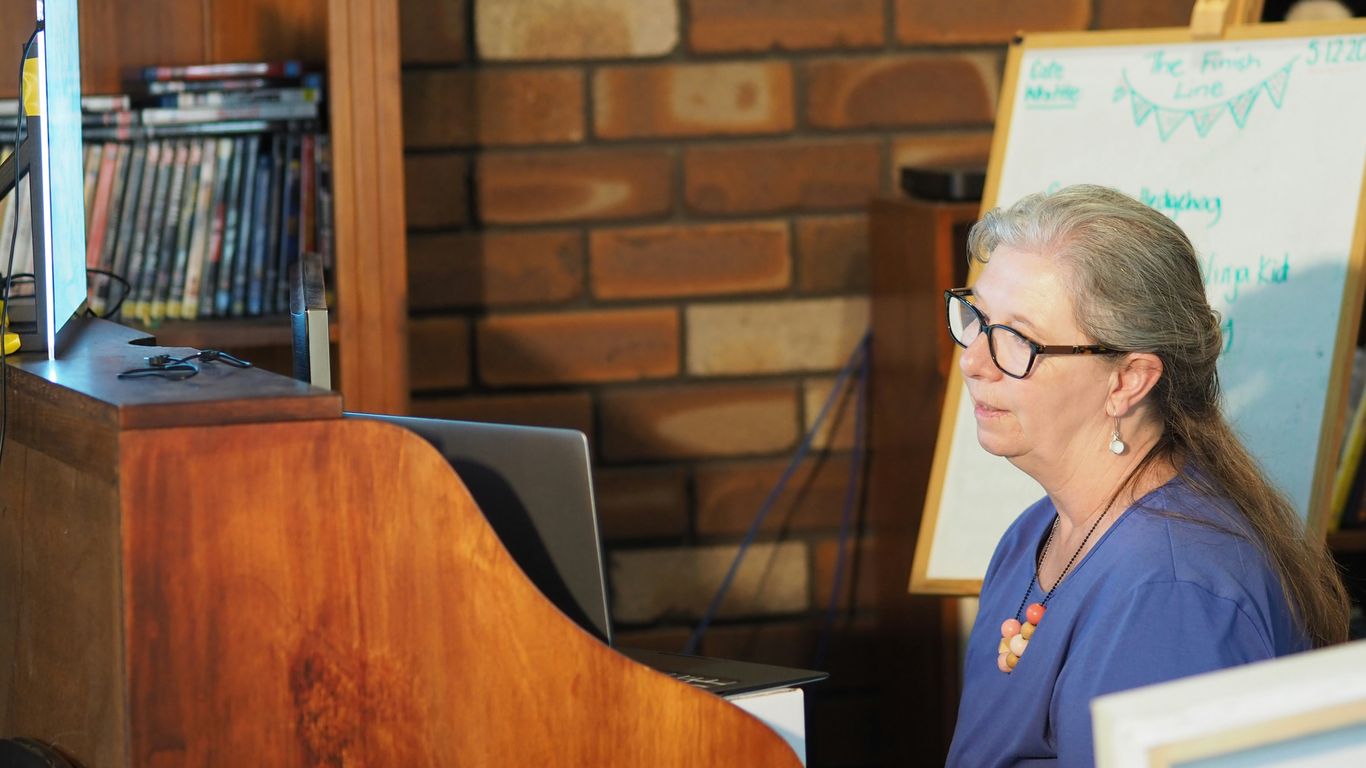 woman in blue polo shirt wearing black framed eyeglasses