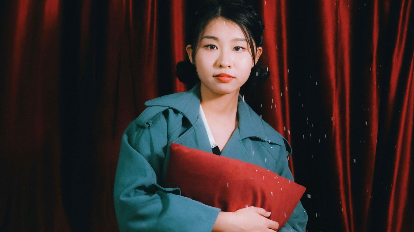 a person holding a red folder