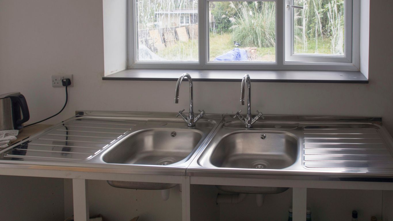 A kitchen with a sink and a window