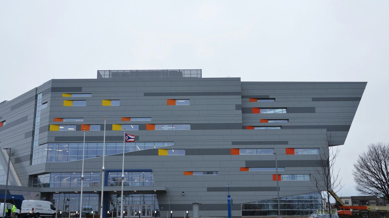 a large gray building with orange and yellow windows