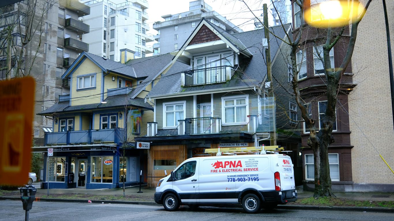 a van parked in front of a row of houses