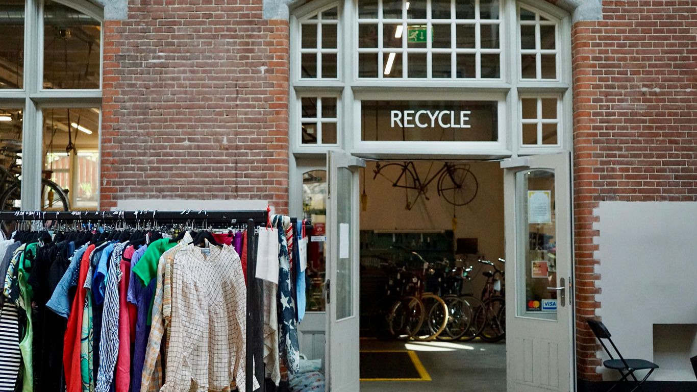 Recycle center with clothes and bicycles inside.