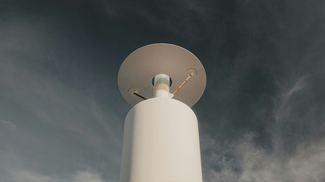 White weather station against a stormy sky