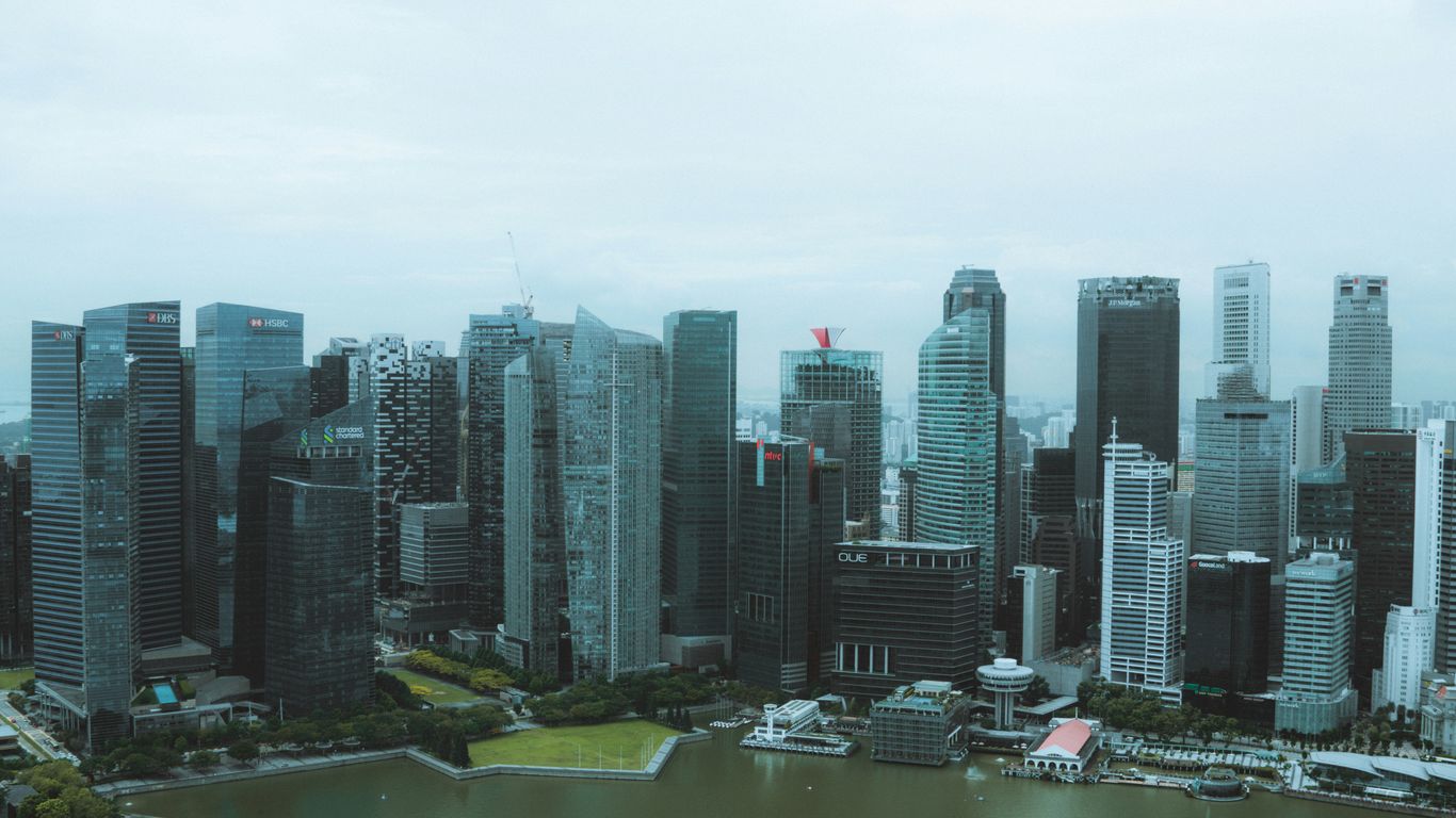 a view of a city with a lake in front of it