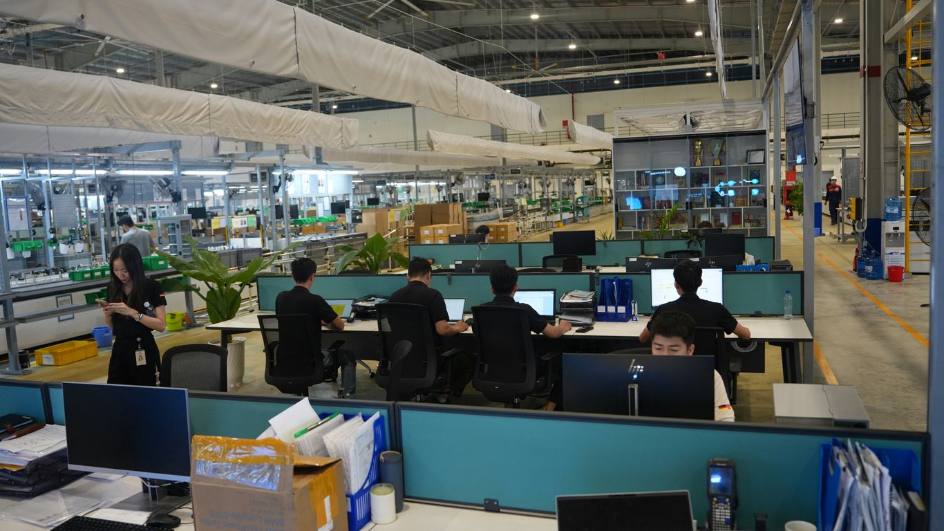People working at computers in a modern office space.