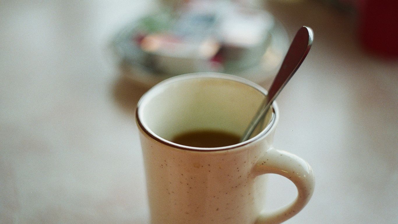 white ceramic mug with stainless steel spoon