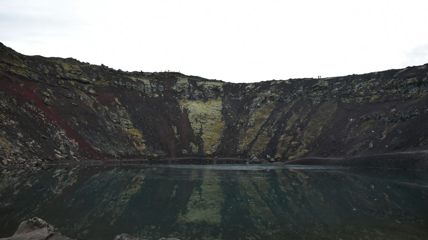 body of water and land during day