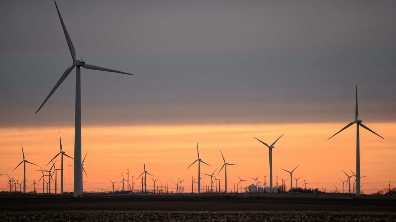 wind turbines on brown field during sunset