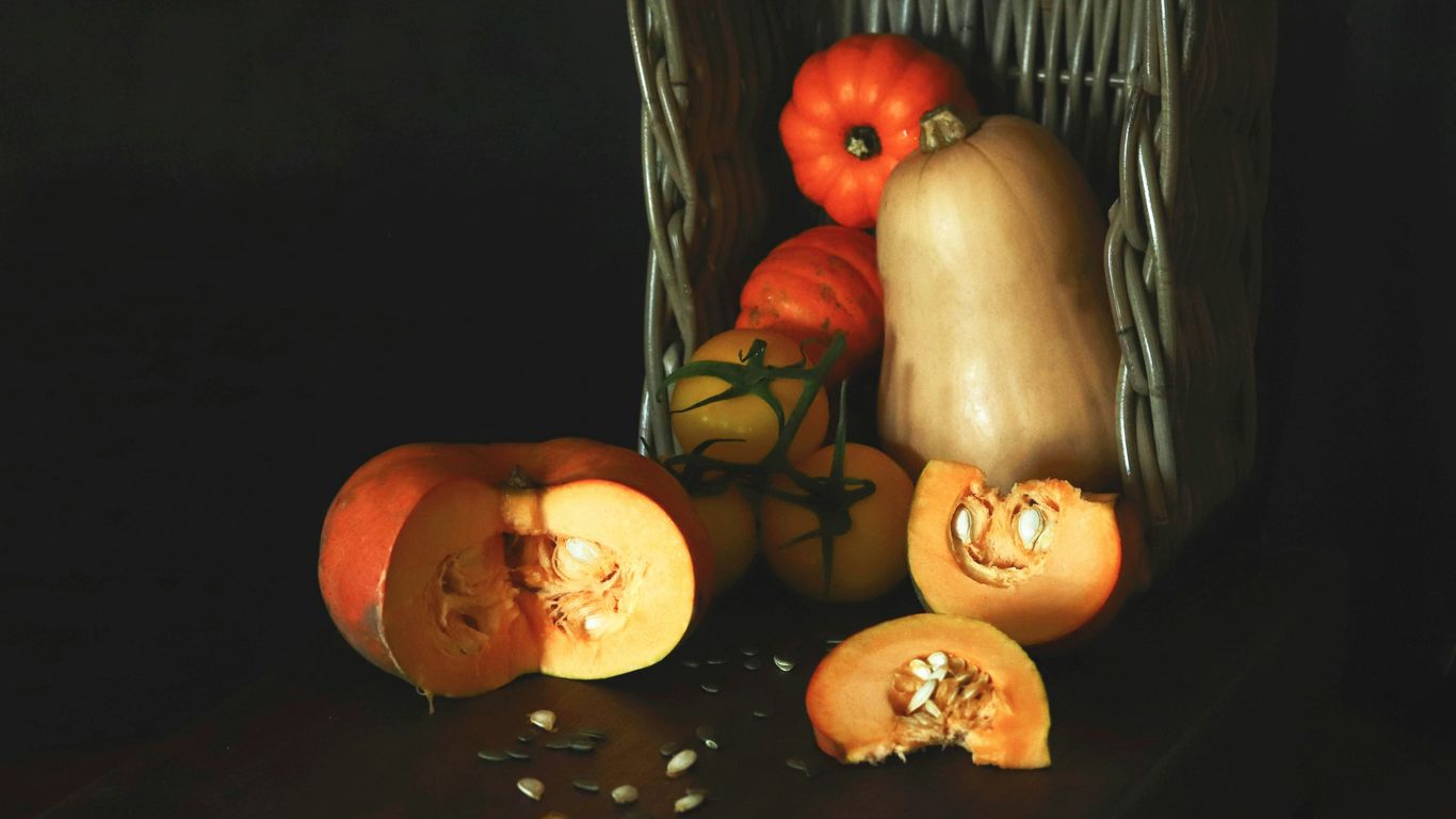 a painting of pumpkins and squash in a basket