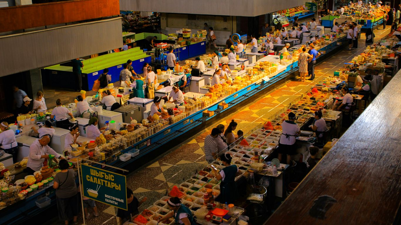 A busy market is filled with vendors and customers.