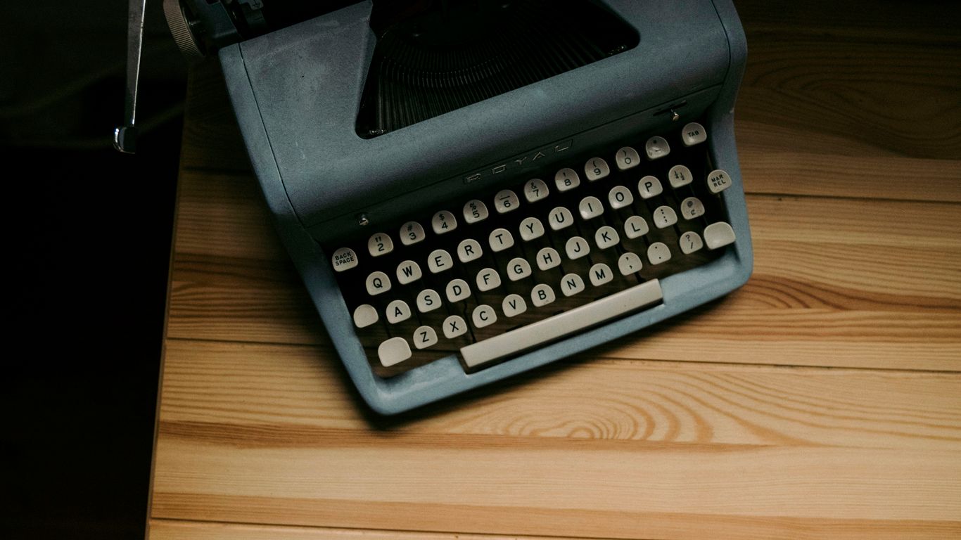an old fashioned typewriter sitting on a wooden table