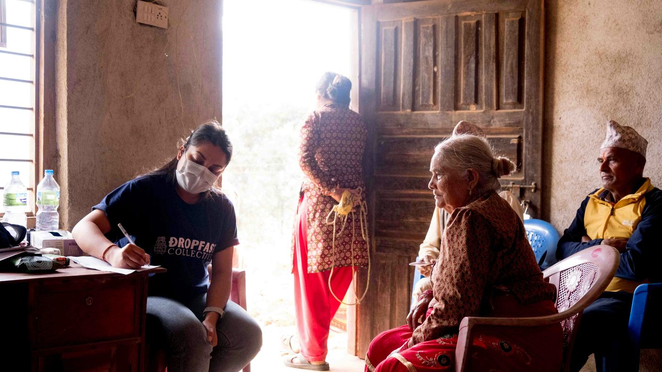 a group of people sitting around a wooden table