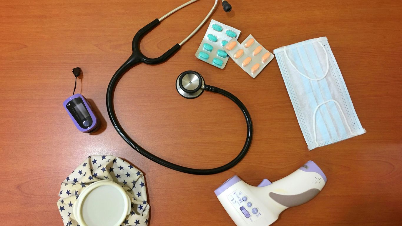 black and silver stethoscope on brown wooden table