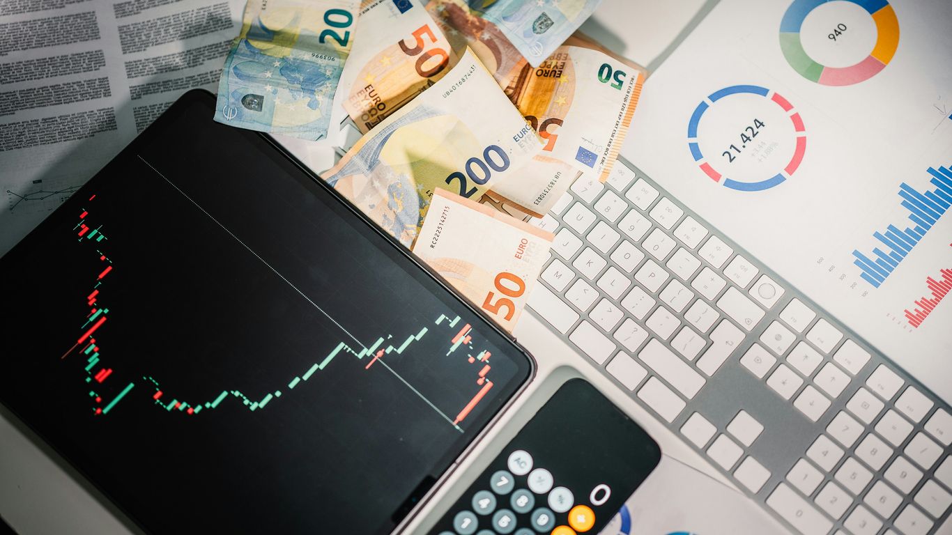 A calculator sitting on top of a pile of money