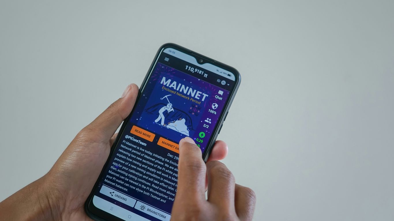 a person holding a cell phone with a website on the screen