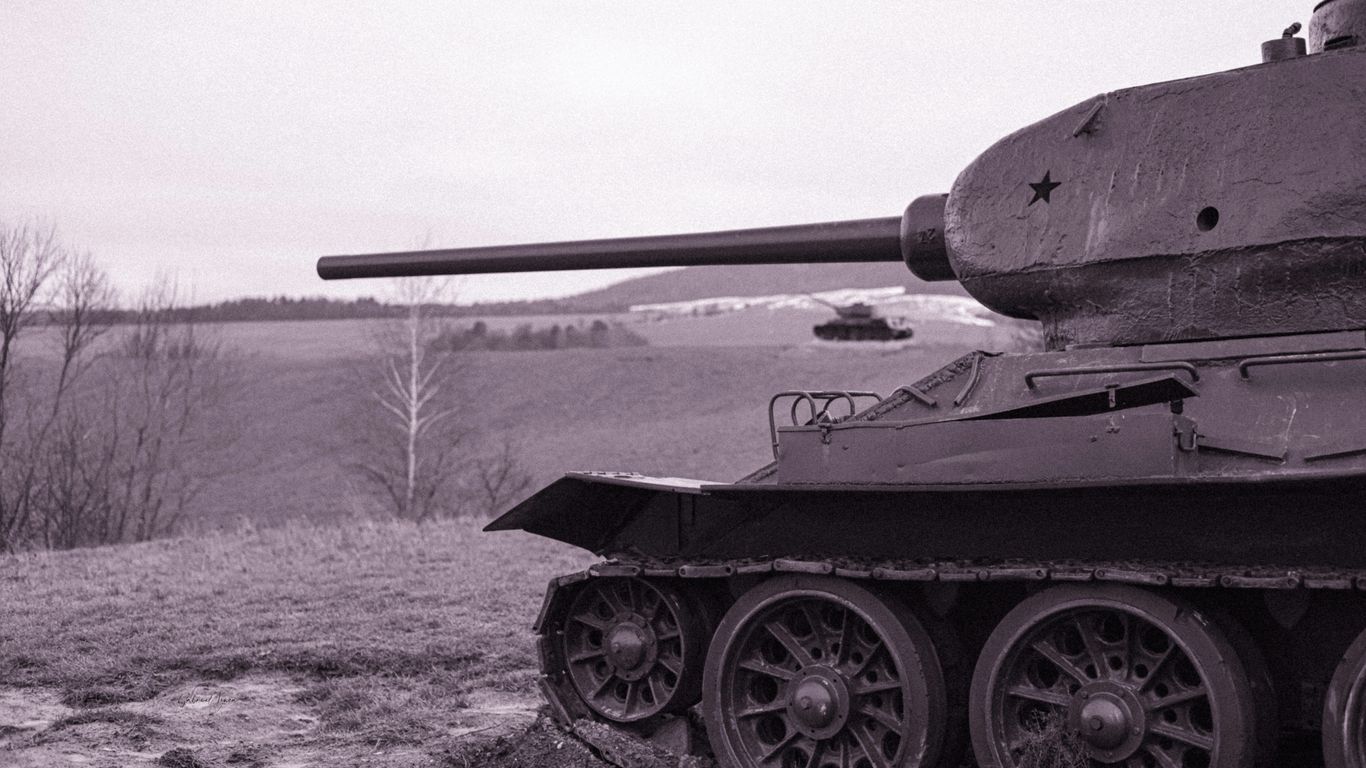 a black and white photo of a tank in a field