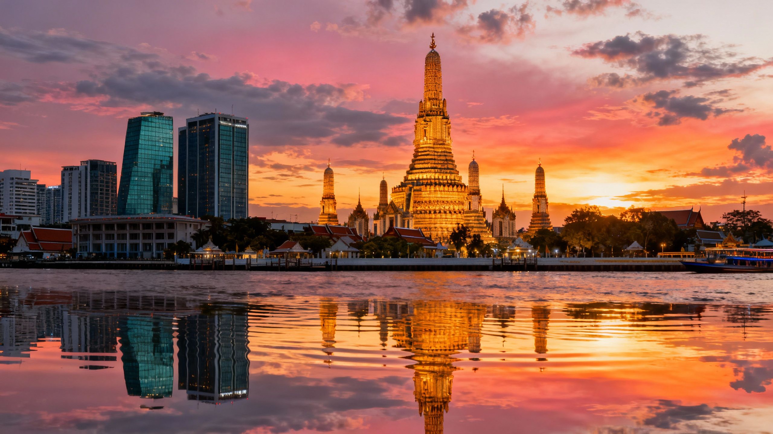 Bangkok skyline with Grand Palace and Wat Arun at dusk.
