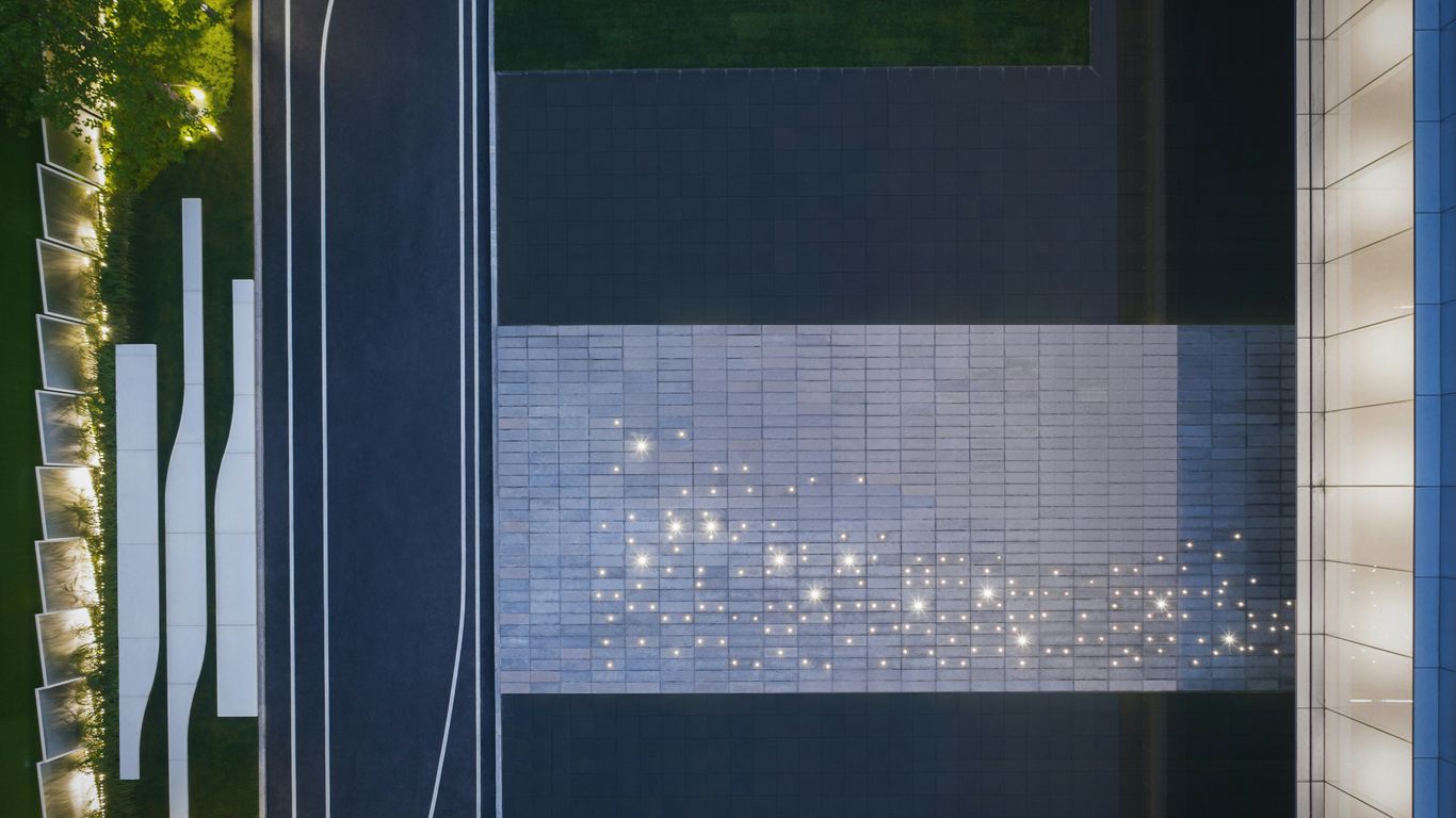 a building with a white and blue wall next to a street