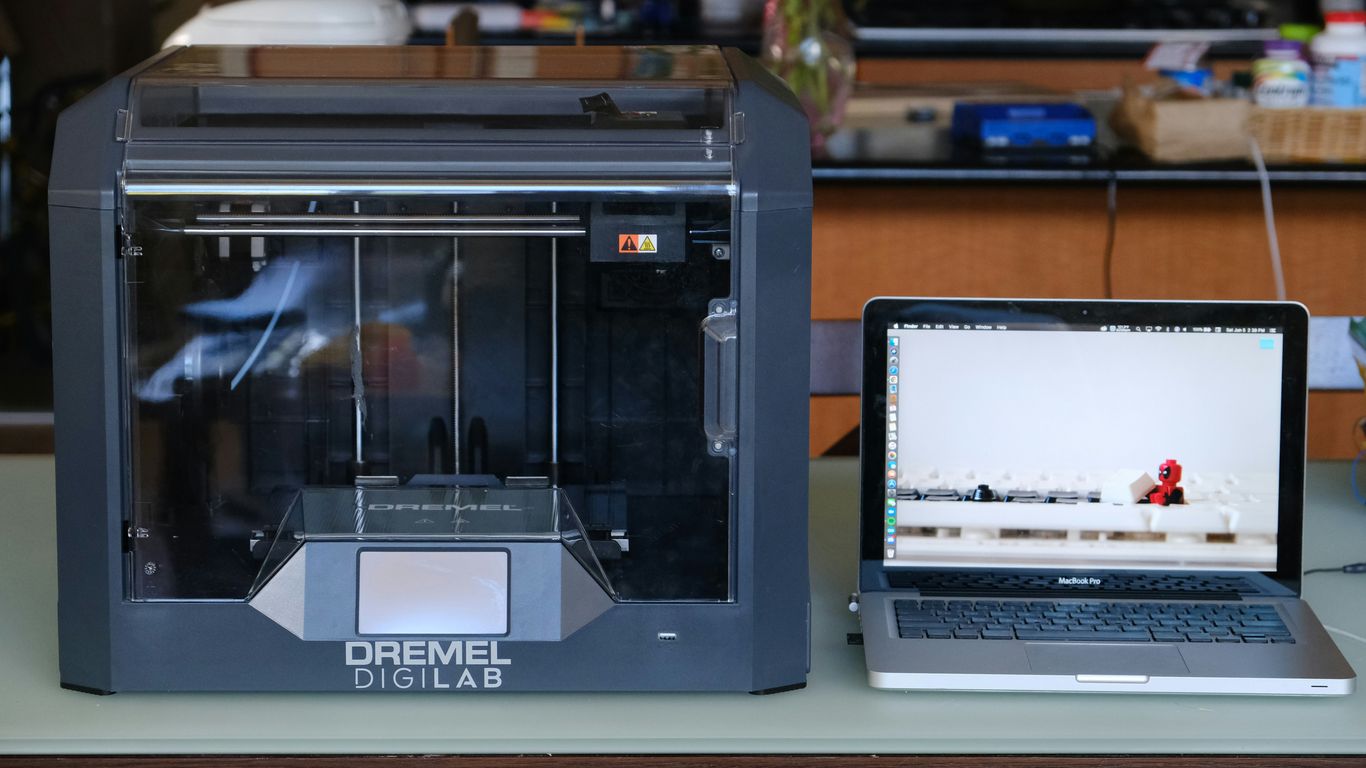 silver macbook pro on white table