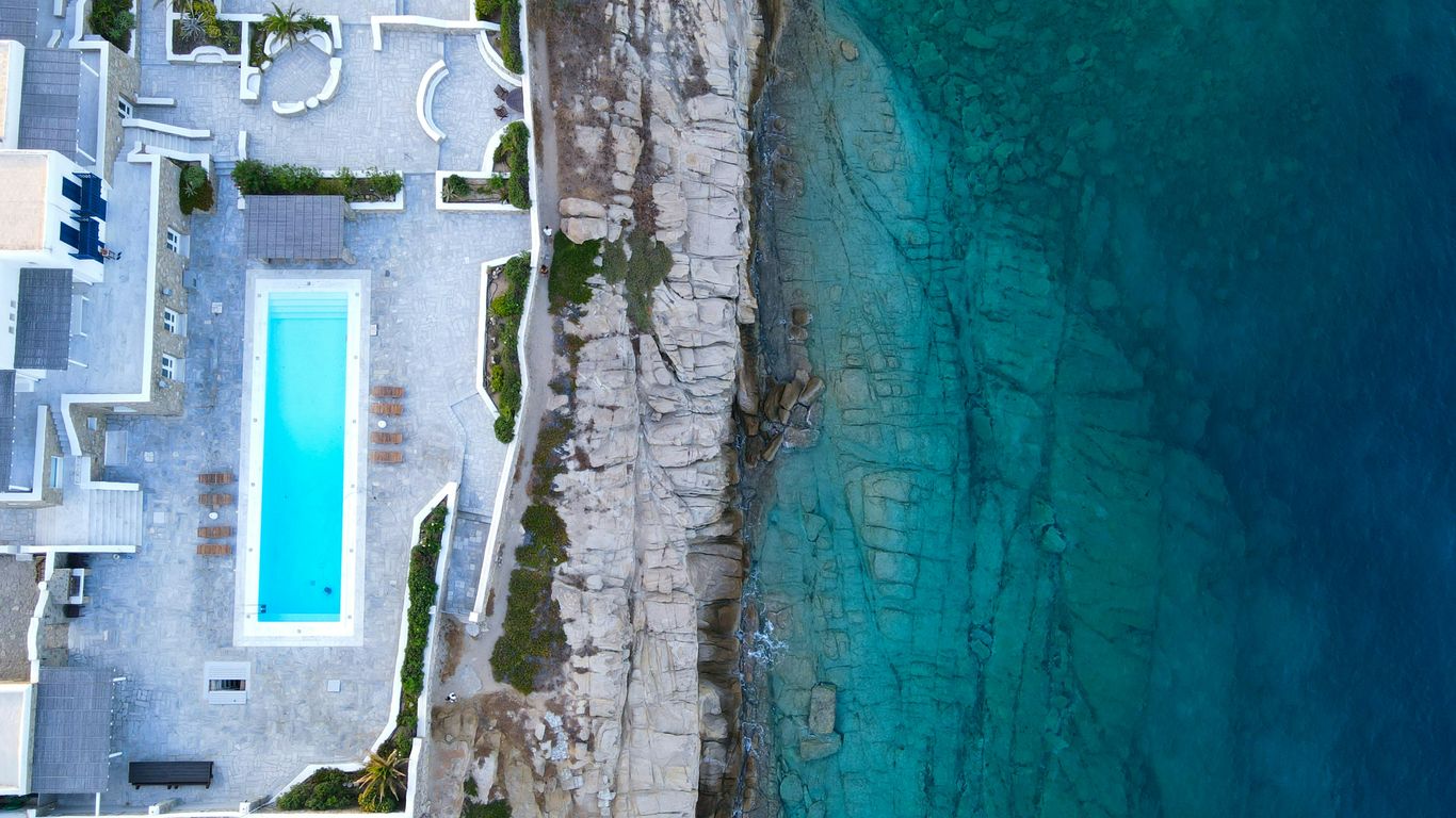 aerial view of white concrete building near body of water during daytime
