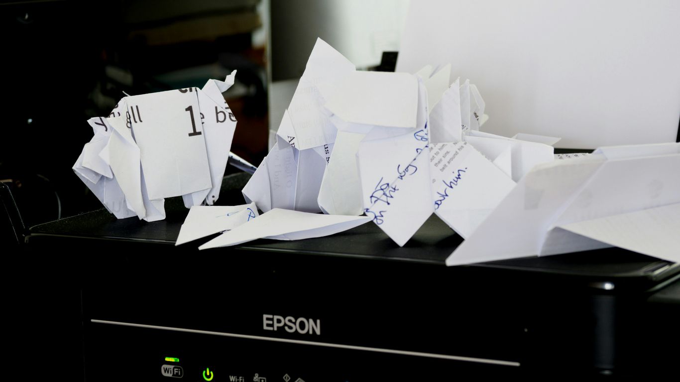 a pile of papers sitting on top of a black box