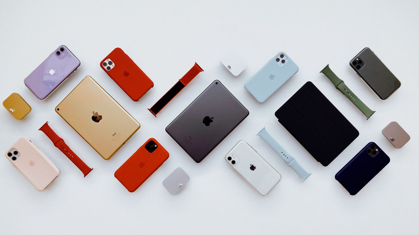 a group of different colored cell phones sitting next to each other