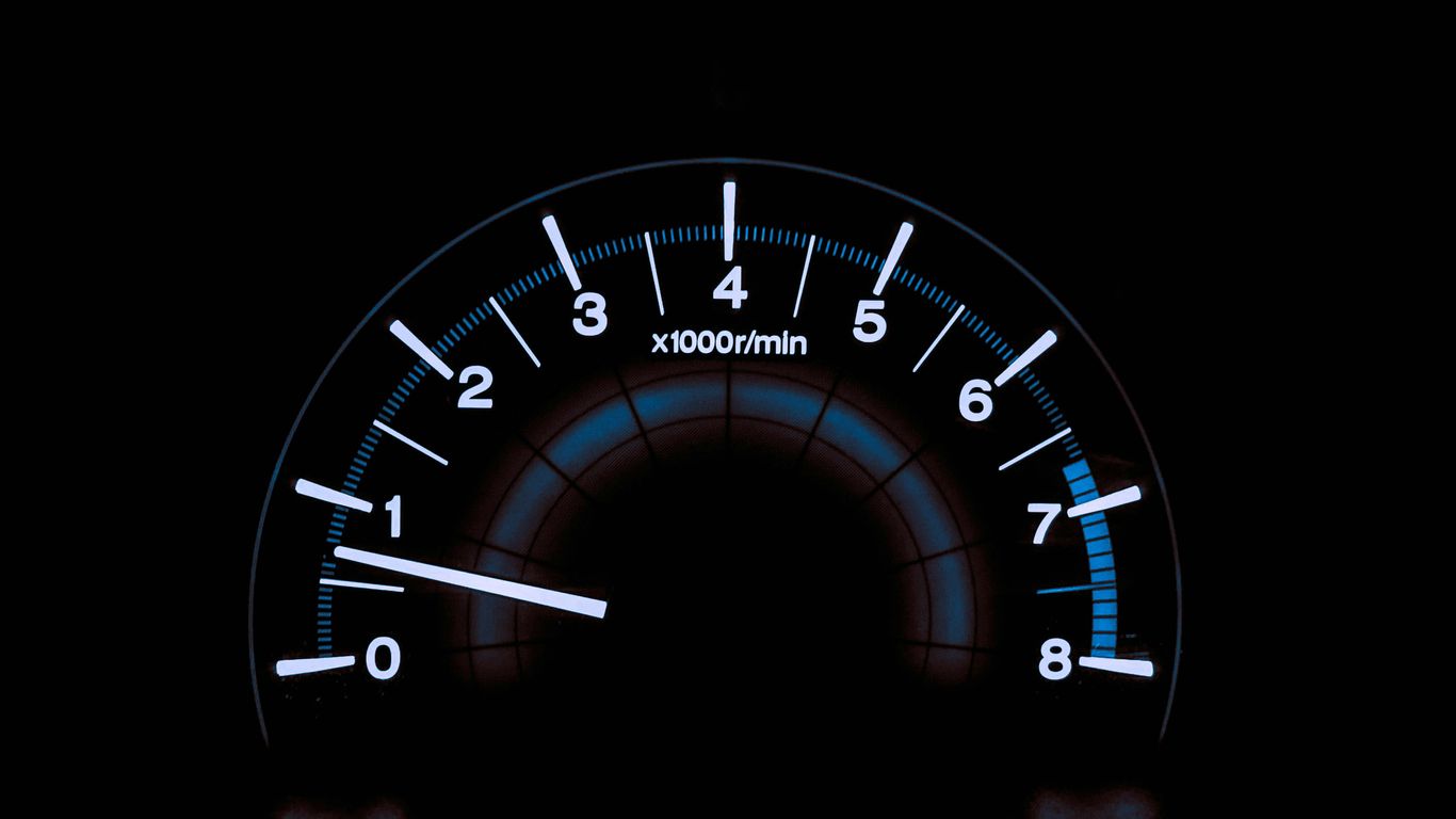 white and blue analog tachometer gauge