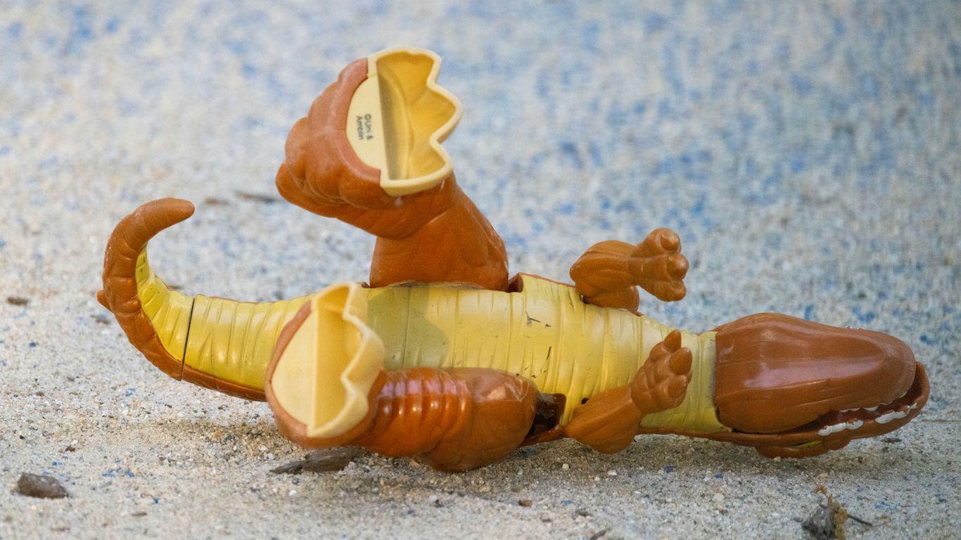 a toy animal laying on its back on the ground