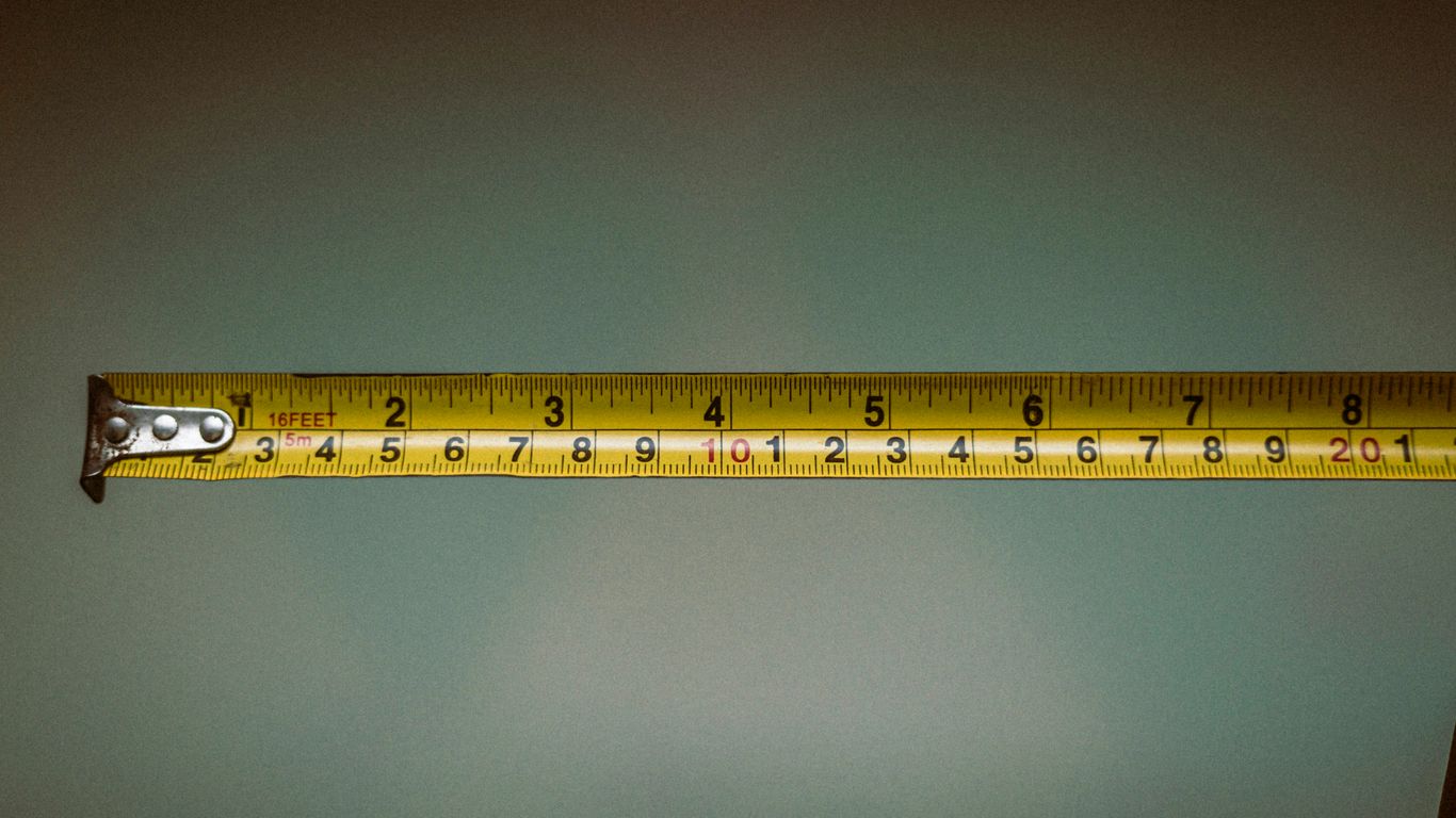 a person holding a tape measure in their hand