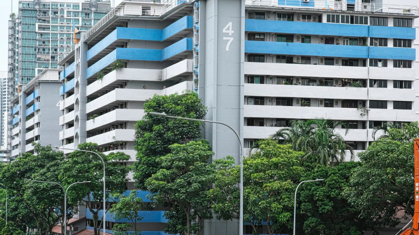 a city street with tall buildings in the background