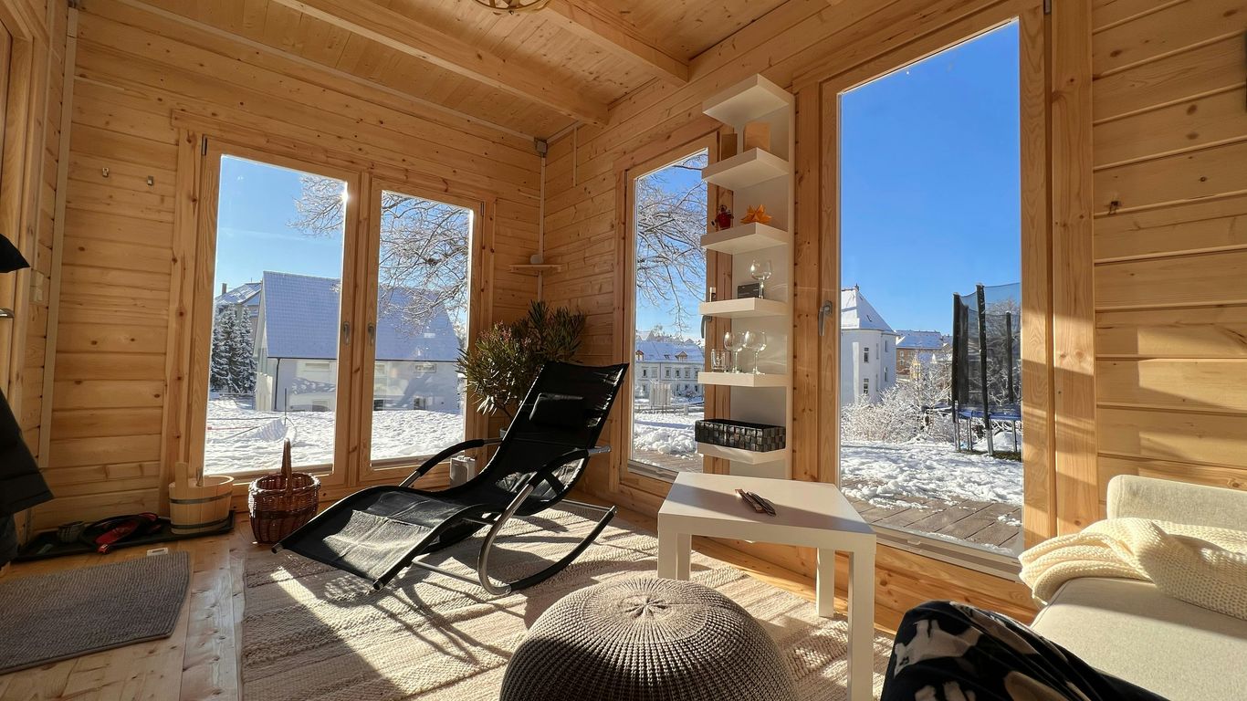 a living room filled with furniture and lots of windows