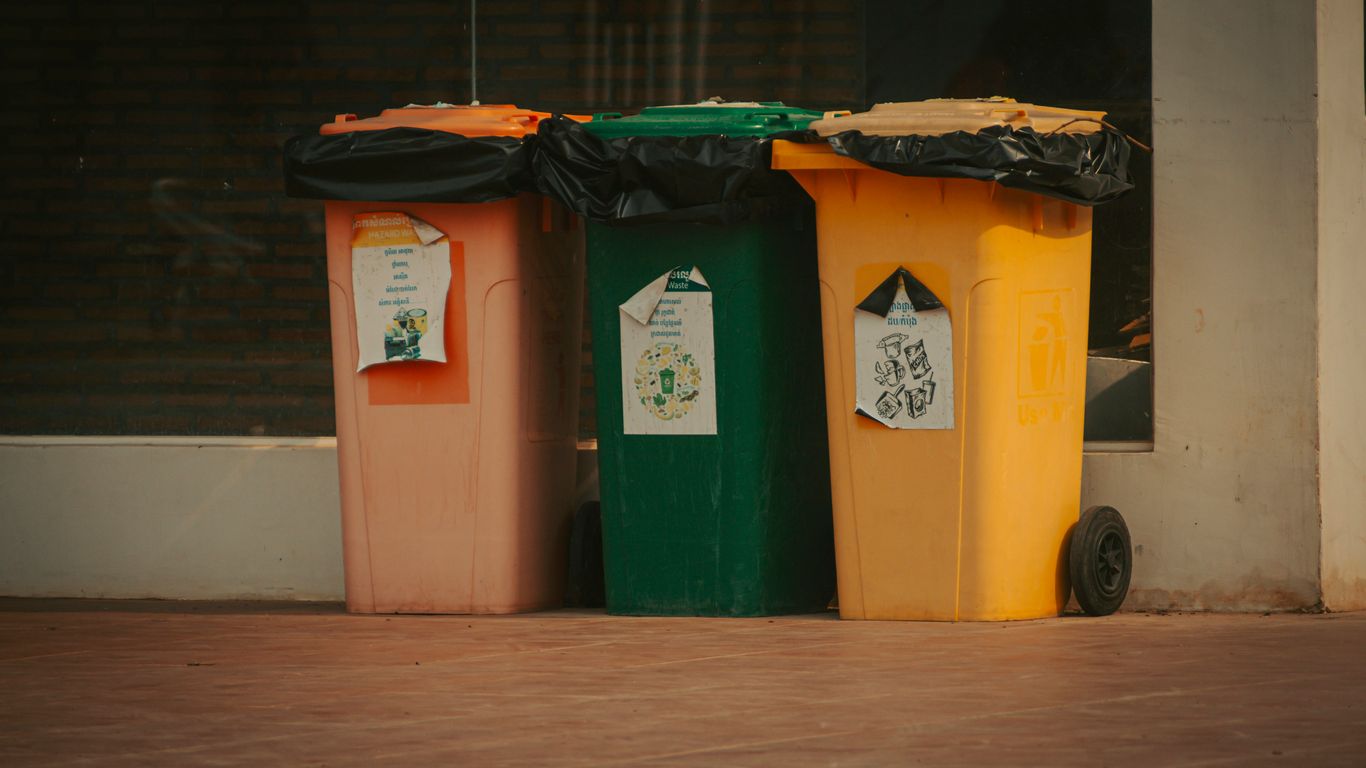 a group of trash cans sitting next to each other