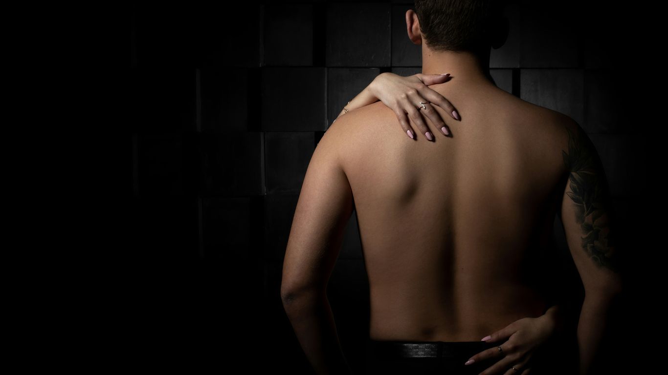 topless man in black pants