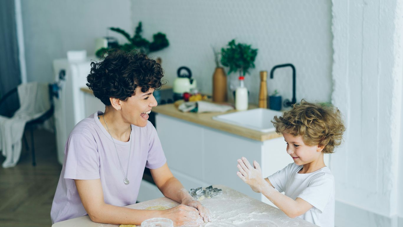 a woman and a child sitting at a kitchen table
