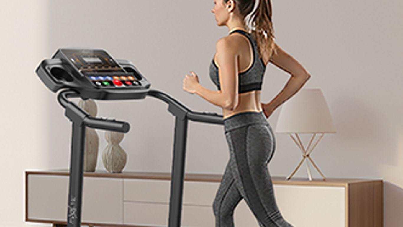 A person runs on a treadmill in a modern home setting.