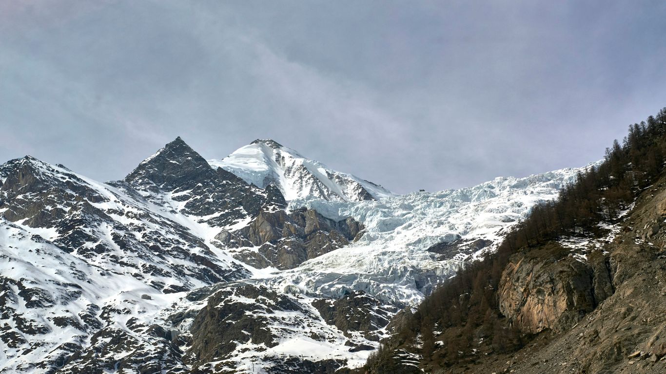 snow covered mountains under cloudy sky during daytime