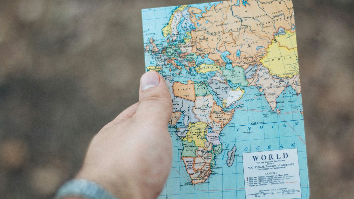 person holding world map